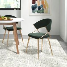 two green chairs sitting on top of a white rug next to a table with fruit