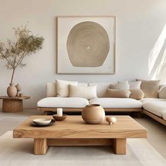 a living room with white couches and wooden coffee table in front of a painting on the wall