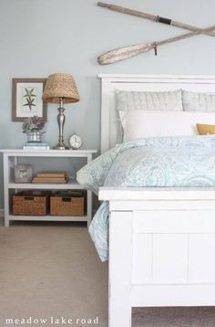 a bedroom with a white bed and blue walls