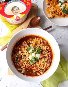 two bowls of soup with noodles and vegetables