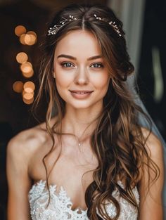 a beautiful young woman wearing a wedding dress and tiara smiling at the camera with lights in the background