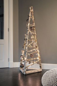 a small wooden christmas tree with lights on it