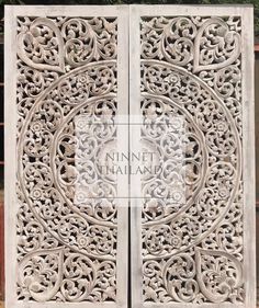 an intricate carved wooden door with carvings on it