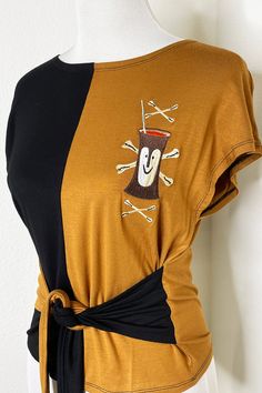 For all our Tiki Bob fans - We present our Tiki Bob Colorblock top! Featuring our original Tiki Bob embroidery and a waist tie that can be tied in the front or back! Made from super soft rayon jersey material that is so soft and stretchy! For a tight fit I would size down since this top runs big! 100% Rayon. Imported. Colorblock Top, Color Block Top, Band Shirts, Running Tops, Tiki Bar, Clothing For Women, Waist Tie, Final Sale, Color Blocking