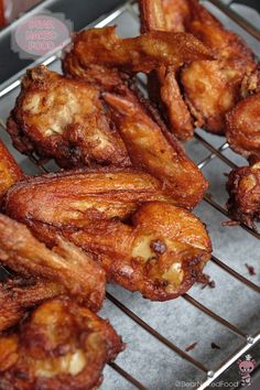 some fried food is sitting on a metal rack and ready to be cooked in the oven