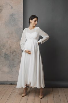 a pregnant woman wearing a white dress