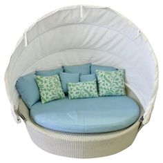 a white and blue couch with pillows on it's back end, in front of a white background