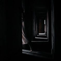 an open door in a dark room with light coming through