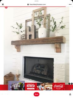 a white brick fireplace with candles and greenery on top