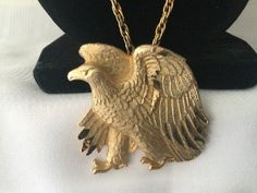 This is a Big or Large Goldtone Eagle Pendant on a Chain Perfect for the Patriotic Man. Very Detailed Standing Eagle with Wings Spread and Measures 1 3/4 inches Tall by 1 5/8 across at Widest. Shiny Tips on Wings on a Duller Detailed Body. The Chain is approximately 23 total. Very Nice Gift! Will come in a box for Gift giving or safe keeping! Eagle Spread Wings Necklace, Box For Gift, Eagle Pendant, Patriotic Gifts, Pearl Grey, Vintage Rhinestone, Red Glass, Gorgeous Necklaces, Big Sale