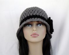 a mannequin head wearing a crocheted hat on top of a white background