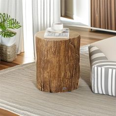 a wooden table sitting on top of a rug in a living room next to a window