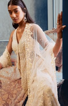 This sharara set features three-dimensional floral sequin, pearl and crystal embroidery. The outfit is paired with embellished v neck top and a four-sided embroidered net dupatta.From Seema Gujral’s Fiori collectionDELIVERY TIMEPlease allow 8-12 weeks for your outfit to arriveFABRIC DETAILSNetProfessional cleaning only Floral Sharara, Seema Gujral, Crystal Embroidery, Indian Gowns Dresses, Traditional Indian Outfits, Indian Gowns, Sharara Set, Ethnic Dress, Net Dupatta