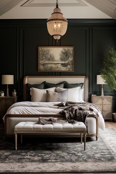 a large bed sitting under a chandelier next to a painting on the wall