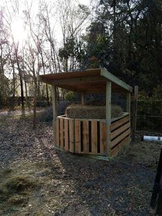 a wooden shelter with hay in it