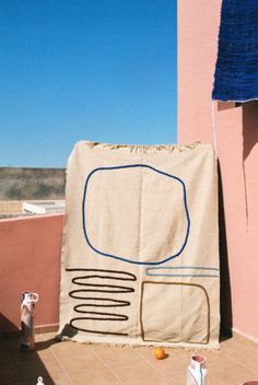 a large piece of artwork on the side of a building with blue sky in the background