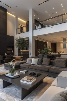 a living room filled with lots of furniture next to a tall ceiling mounted high up