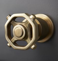 a close up of a door handle on a gray wall with a black and white background