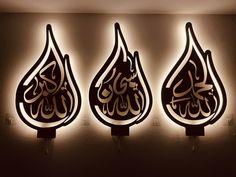 three lamps with arabic calligraphy on them