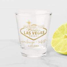 a shot glass with the words save the date printed on it next to a lemon