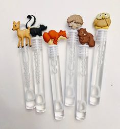 five plastic animals are in the shape of pencils