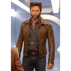 a man in a brown leather jacket and jeans