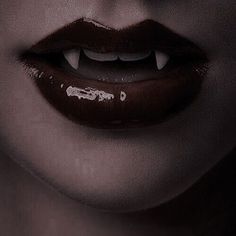 a woman's lips are painted with white paint and the lip is dark brown