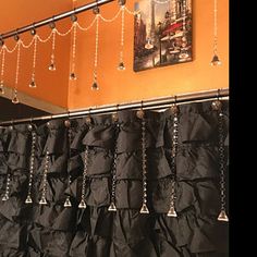 the curtains are lined up against the wall and hanging from the hooks on the curtain rod