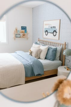 a bed room with a neatly made bed and a teddy bear