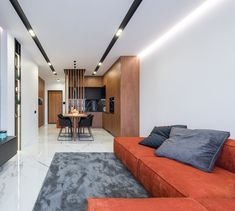 a living room filled with furniture next to a kitchen