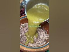 green liquid being poured into a bowl filled with food