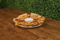 a stack of flatbreads sitting on top of a wooden table