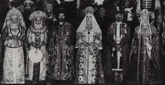 an old black and white photo of people dressed in medieval garb, standing next to each other