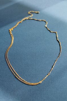 A double Rolo Chain on one side and a Dapped Bar Chain on the other. Sold individually 16" long with a 2" 24K Gold Filled extender chain 1.2mm Rolo Chain 0.9x8.2mm Dapped Bar Chain 4 grams in weight Please expect slight imperfections, as this necklace is assembled by hand Double Strand Gold Plated Figaro Chain Necklace, Gold Plated Double Strand Figaro Chain Necklace, Gold Double Strand Figaro Chain Necklace, Dainty Double Strand Figaro Chain Necklaces, Minimalist 14k Gold Double Chain Necklace, Gold Figaro Chain Lariat Necklace, Gold Lariat Figaro Chain Necklace, Dainty Multi-strand Figaro Chain Necklace, Gold Lariat Necklace With Figaro Chain