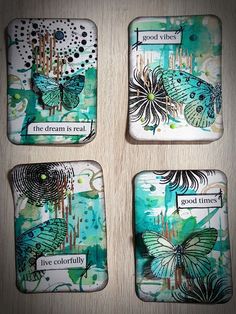 four coasters with butterflies painted on them