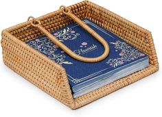 a wicker basket with a blue book in the middle and an umbrella on top