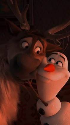 an animated character kissing another character with antlers on his head in the disney movie frozen princess