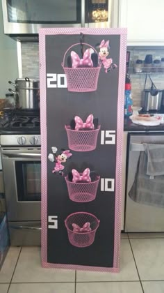 a sign with pink bows on it in the shape of baskets and numbers that read 20