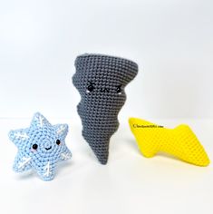 three crocheted toys are sitting next to each other