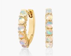 14K Yellow Ethiopian Opal Row Hoop Earrings. A row of petite opal cabochons are set in fine 14K yellow gold huggie hoop earrings. Carved Wedding Ring, Gold Huggie Hoop Earrings, Huggie Earrings Gold, Classic Wedding Rings, Huggie Hoop Earrings, Mens Wedding Rings, Dream Jewelry, Ring Collections, Huggies Earrings