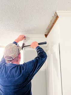 a man with a wrench is working on the ceiling