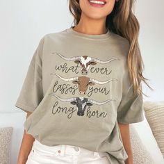 Howdy, adventure lover! Ready to express your unique style with a touch of Western flair? The Whatever Lassos Your Long Horn Comfort Color Graphic Tee is perfect for those who love a bit of cowboy charm in their wardrobe. Whether you’re heading to a country fair, a rodeo, or just enjoying a laid-back day, this tee combines comfort with a playful nod to the Wild West. Crafted from ultra-soft, high-quality cotton, the Whatever Lassos Your Long Horn Comfort Color Graphic Tee ensures comfort and dur Bulls Shirt, Long Horn, Country Fair, The Bull, The Wild West, Western Theme, Line Dancing, Comfort Color, Wild West