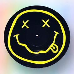 a black and yellow smiley face with two crosses on it's forehead is shown