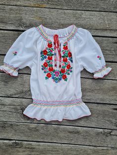 Handmade, hand embroidered and hand smocked folkblouse, Hungarian  Hand Embroidered blouse. Amazing embroidery Lenght 26 inch Bust : 43 - 44inch White Folk Peasant Top For Festival, Traditional Spring Blouse With Machine Embroidery, Folk Style Embroidered Peasant Top For Festivals, Folk Style Multicolor Embroidered Peasant Top For Festivals, Folk Style Peasant Top With Multicolor Embroidery For Festival, Spring Folk Style Tops With Machine Embroidery, Folk Style Spring Tops With Machine Embroidery, Spring Folk Tops With Machine Embroidery, Fitted White Folk Peasant Top