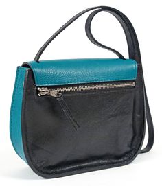 "This beautiful and lightweight saddle bag will add some edge to your fashionable wardrobe. Crafted from a smooth black cowhide, teal/blue/silver leather and black suede interior. This bag also features an exterior zipper pocket, (2) interior patch pockets, snap/flap closure, silver hardware and hand painted edges. Handmade in Denver, CO USA. Width- 9\" Height- 7\" Depth- 3\" Strap drop- 18\" Weight- 13 oz Not finding exactly what you want? Sean Ray can make it for you! Custom orders available n Blue Leather Shoulder Bag With Zipper Pocket, Modern Black Soft Leather Saddle Bag, Black Soft Leather Saddle Bag For On-the-go, Blue Crossbody Saddle Bag With Removable Pouch, Black Leather Saddle Bag With Removable Pouch, Blue Leather Saddle Bag For Daily Use, Modern Black Saddle Bag With Leather Lining, Blue Saddle Bag With Removable Pouch For Everyday Use, Everyday Blue Saddle Bag With Removable Pouch