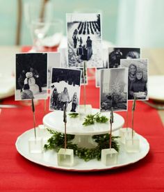 a white plate topped with pictures on top of a red table cloth and place settings