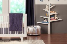 a baby's room with a book shelf and crib