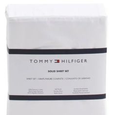 the tommy hilfiger solid sheet set is white with black trim and features a logo on it