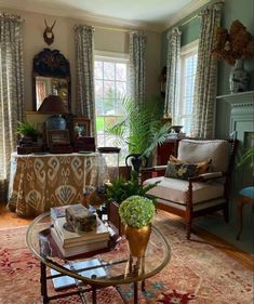 a living room filled with furniture and lots of windows covered in drapes, curtains