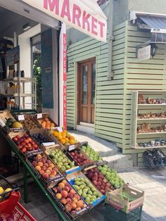 the fruit stand has many different types of fruits on display for sale in front of it